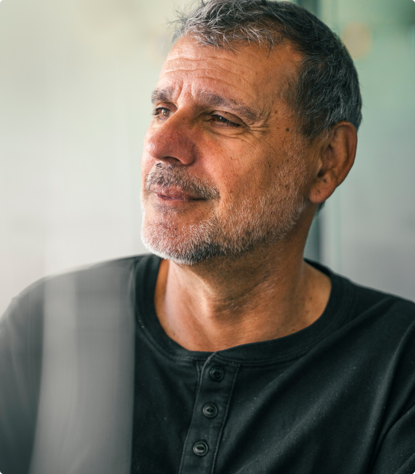 Portrait of John Santos through a glass window