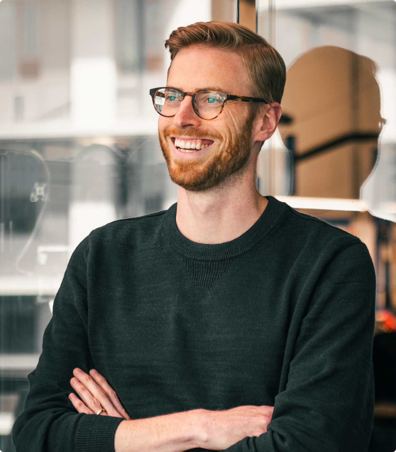 Portrait of Rory Biskupski in front of clear glass windows