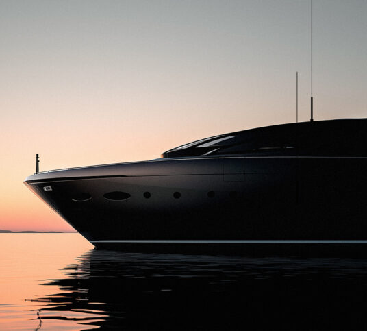 Side view of the front half of a speedboat, nearly silhouetted against a horizon at dawn.