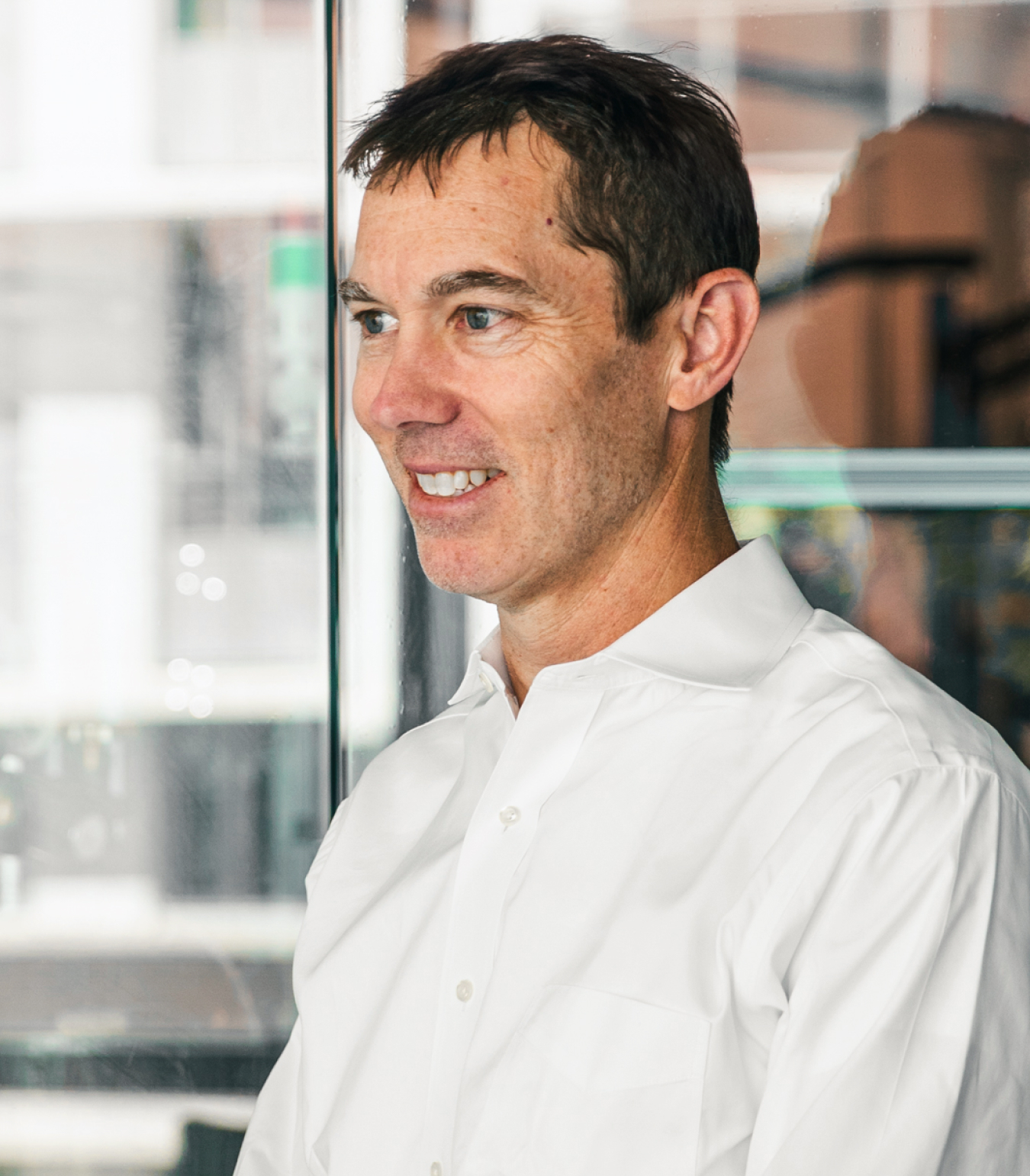 Portrait of Mike Slowik in front of clear glass windows