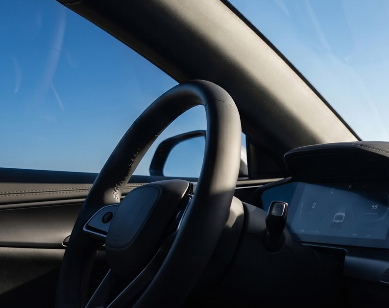 A close up of the steering wheel on a modern car.