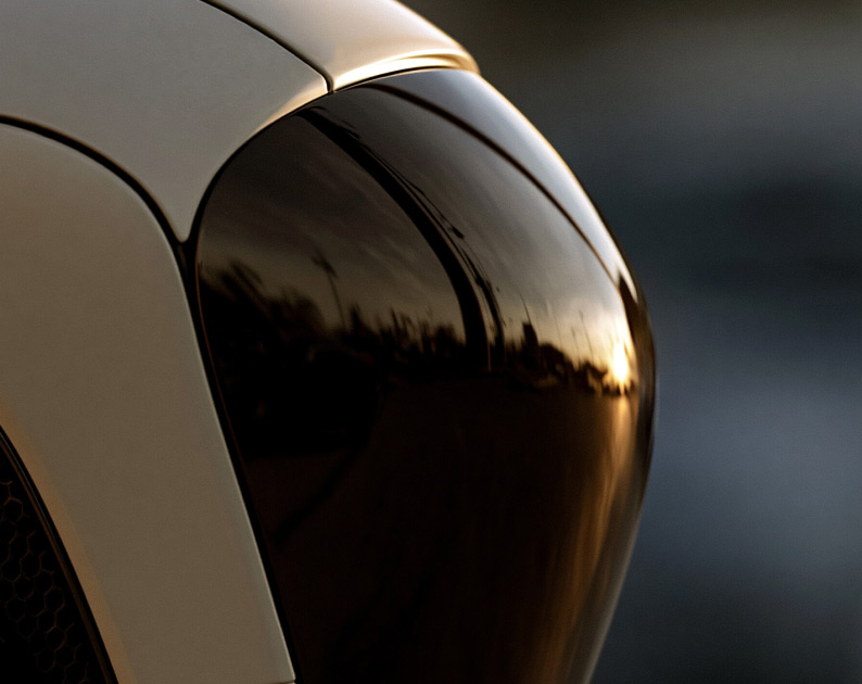Close up of a robot head with bright sun reflecting from visor.