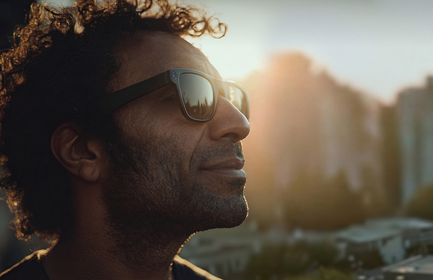 A man wearing augmented reality glasses in bright sunlight.
